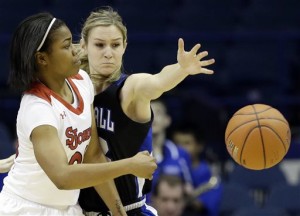 St. John's guard Keylantra Langley, left, passes against Seton Hall guard Tara Inman during the first half of an NCAA college basketball game in the quarterfinals of the 2014 Big East women's tournament in Rosemont, Ill., Sunday, March 9, 2014. (AP Photo/Nam Y. Huh)